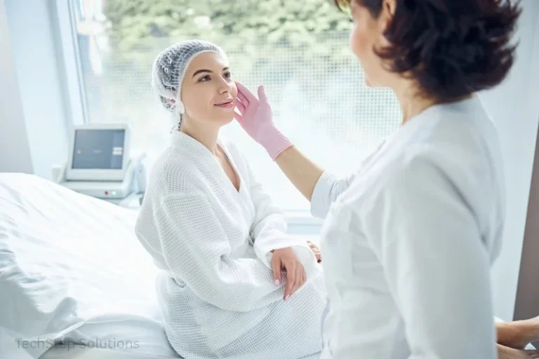 Provider examining a client's skin during a consultation in a treatment room.